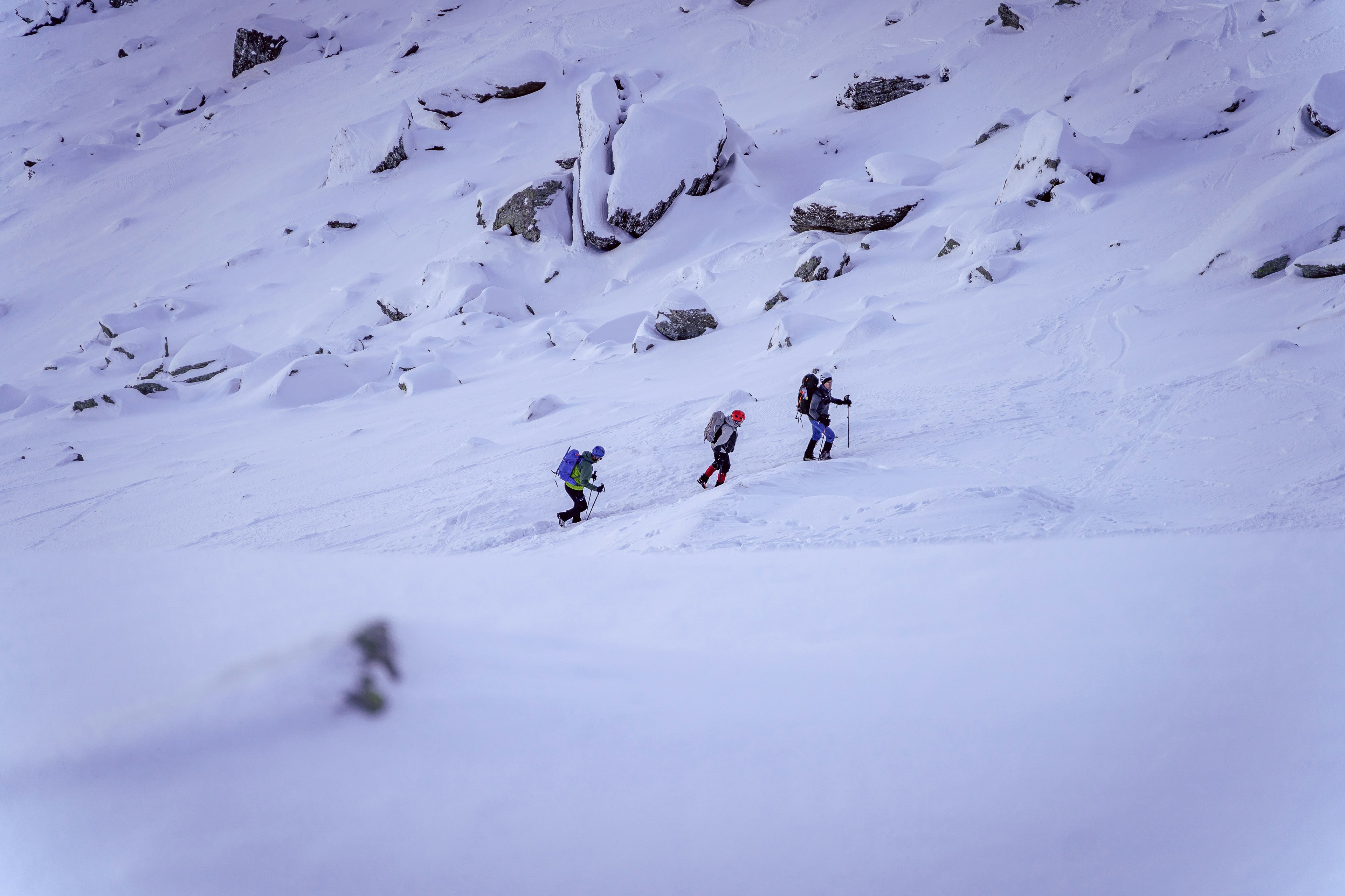 people walking on snow covered mountain during daytime